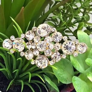 Gold plated metal with clear crystals. Made with Swarovski crystals.